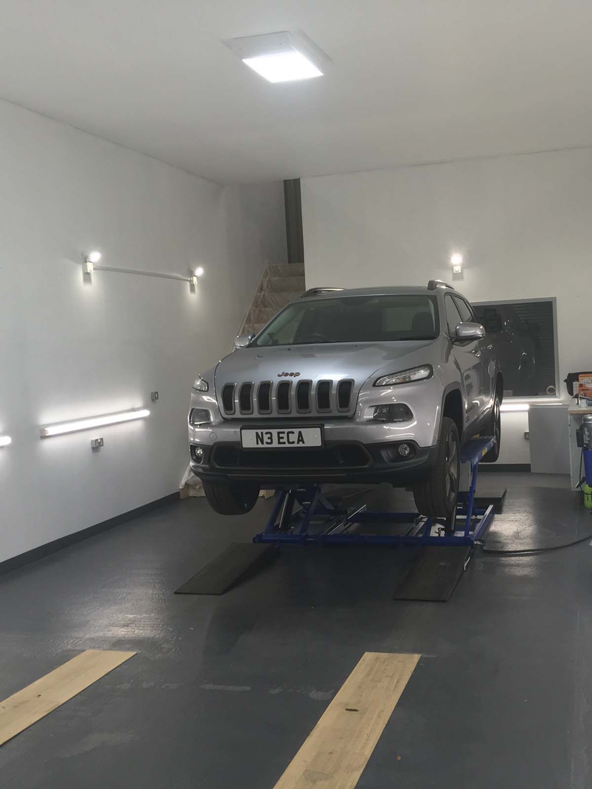 garage interior with lifted car